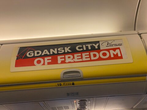 Palma, spain, january 20, 2026, gdansk city of freedom and lech walesa airport advertisement on airplane overhead bin, promoting travel to poland