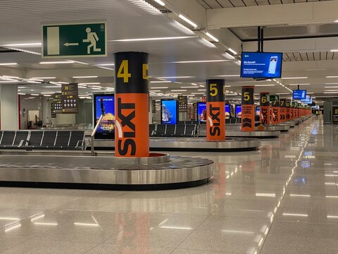 Palma, spain, january 20, 2026, airport baggage claim hall with multiple luggage carousels and sixt advertising pillars, travel concept