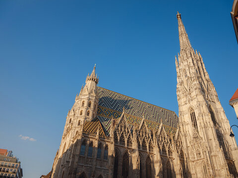 Summer view of Vienna Stephansplatz with iconic cathedral and surrounding old town streets, historic architecture, lively city atmosphere, European travel destination, cultural urban scene.