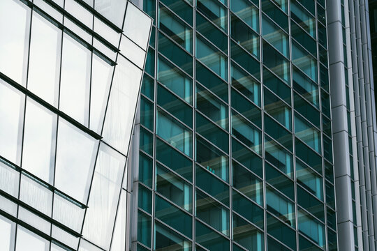 Modern architecture facade with glass grid and frames on tall structure using perspective to form abstract pattern background for design