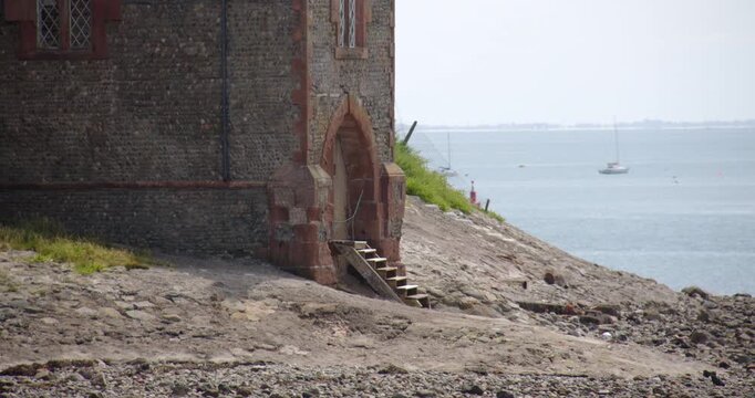 Mid shot of the Watch Tower at low tide on roa island, near barrow in furness,