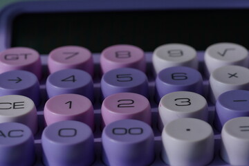 Stylish purple pastel calculator on a desk, modern office stationery.