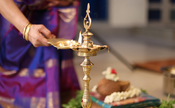 lady lighting a lamp