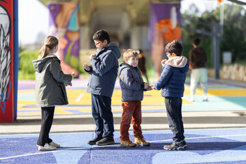 Obraz premium Children playing outdoor game on colorful urban pavement