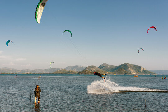 The photo shows a windsurfer surfing. The location is the Neretva River estuary, Croatia.