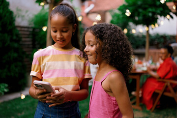 Obraz premium Girls Recording Videos and Taking Photos on Smartphone at Family Gathering