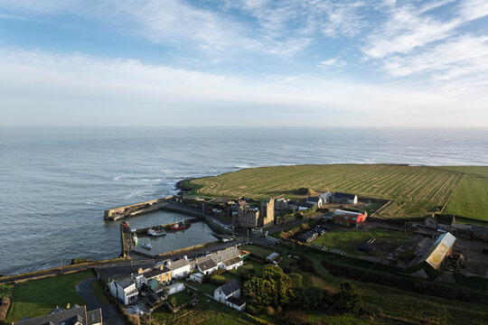 Wide aerial view of Slade village and Slade Castle on the Hook Peninsula, winter harbour and Atlantic coastline