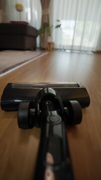 A person point of view shot of cleaning the house with a vacuum cleaner at home