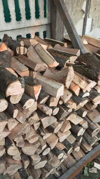 A pile of firewood lies stacked in a warehouse