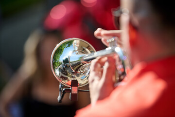 Close-up of trumpet player with reflective bell in outdoor setting © TRAVELARIUM