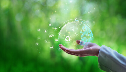 Naklejka premium Businesswomen holding world and icon to Organization Sustainable development environmental. business responsible environmental,