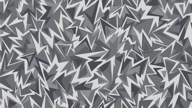 Aerial view of a chaotic geometric pattern of jagged shapes and abstract designs in various shades of gray