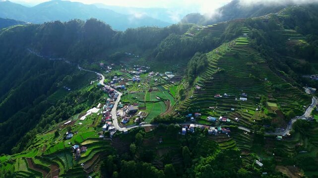 Slow pan right aerial view of Halsema Highway Atok Benguet Philippines with rolling farmland and scenic terrain
