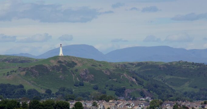 Long shot sir john barrow monument Hoad, with Ulverston in Foreground and Coniston Mountains background, from Birkrigg Common