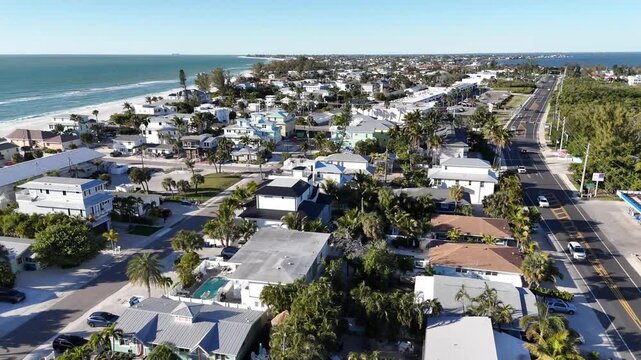 sliding sideways aerial from inside the island to the beach an high waves water on Holmes, Bradenton Florida beach area