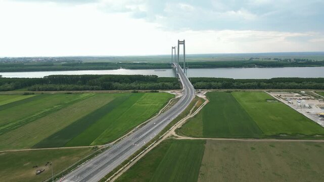 The Braila Road Suspension Bridge Over The Danube River In Romania. Aerial Pullback Shot