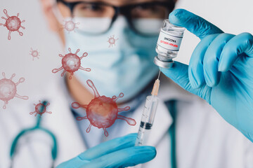 Doctor holding a Nipah virus vaccine vial and syringe with floating virus cells, symbolizing...