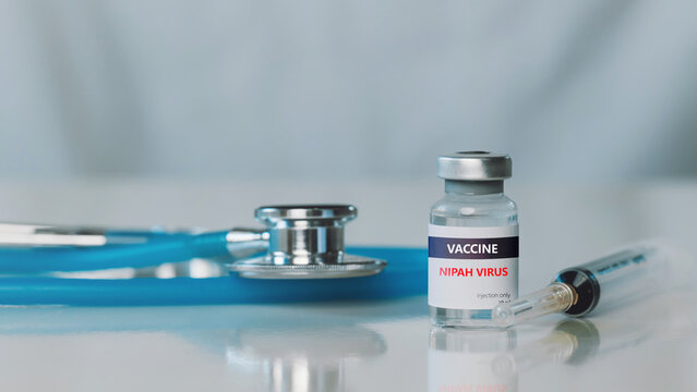 Medicine and health concept.Medical still life of a Nipah virus vaccine vial with syringe and stethoscope in a clean laboratory, symbolizing outbreak prevention, immunization, and disease control.