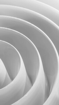 Swirling patterns in grey shapes on a smooth surface create a captivating visual experience at midday