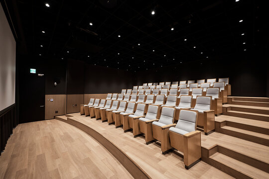 Modern lecture hall interior with tiered seating and wooden accents