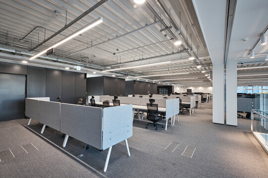 Contemporary open office space with workstations and industrial ceiling
