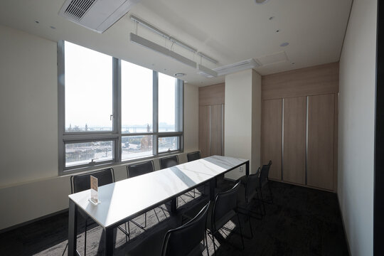 Small modern meeting room with large window and city view