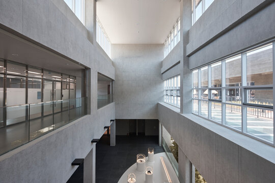 High-ceiling atrium in modern office building with glass railings
