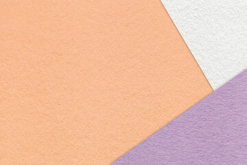 Fototapeta premium Peach textured paper background with white lilac triangular corners and copy space. Template for presentation, banner