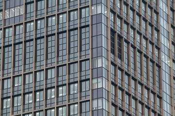Fototapeta premium Geometric pattern of modern glass skyscraper facade