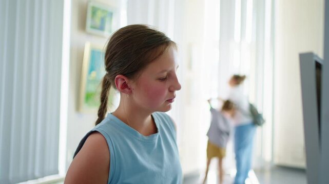 A Young Girl Observes Art at an Exhibit, Engaged and Curious, in a Bright Gallery Surrounded by Vibrant Paintings and Unaware Visitors Around Her