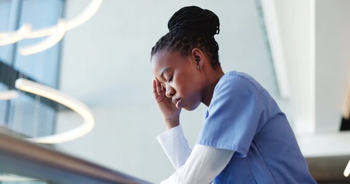 Black woman, nurse and headache in grief, stress or mistake on floor in hospital. Mental health, sad physician and medical person with low angle anxiety for burnout, loss or failed surgery at clinic