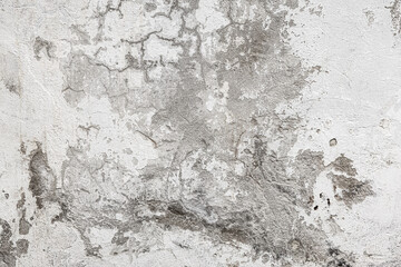 Obraz premium A close-up of a dirty white wall featuring smudges, dark stains, cracks, and scratch marks. Rough texture and aged surface with ample copy space