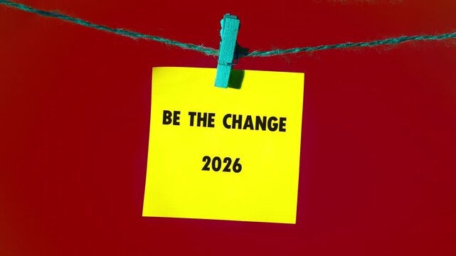 Witness a journey of words, as individual letters scattered on a luminous yellow field slowly coalesce into the profound call Be the Change 2026
