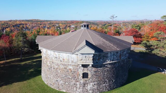 Cinematic View Of Prince Of Wales Tower Nestled In Vibrant Fall Leaves During Golden Sunrise. Drone Captures Peaceful Heritage Landscape In Canadian East Coast City. 