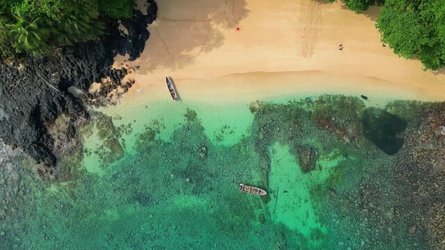 View from above of one of the most beautiful beaches on Pr&iacute;ncipe Island, where we can see two anchored boats and the magnificent turquoise sea. S&atilde;o Tom&eacute;,Africa