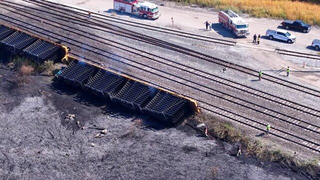 Train derailment and fire near I75 in Woodhaven, Michigan with emergency response. Firefighters fighting consequences of train crash in USA, aerial view
