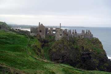 Naklejka premium Ancient Dunluce Castle Ruins on a Cliff in Northern Ireland