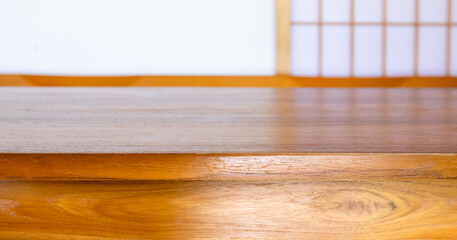 Warm wooden tabletop with blurred Japanese interior background. Ideal for product display, mockup, copy space, advertising, and minimalist design use