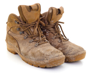 Pair of old dirty work boots isolated on white background