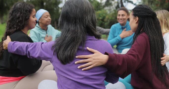 Multi generational women's circle during a group meditation with people of different ethnic and body types - Healthy lifestyle, yoga class and emotional healing concept 