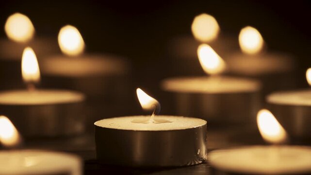 Many burning candles in the dark. Memorial day. Funeral candles