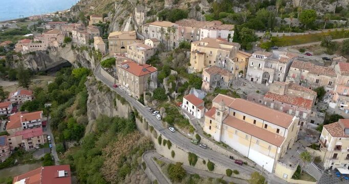 Aerial view of a historic Mediterranean hillside village. Panoramic of the old town of Amantea, in province of Cosenza, Calabria, Italy. The historic center is perched on a mountain.