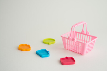 Pink basket is surrounded by color speech bubble on white background copy space. Customer feedback or comment from shopping offline, online e-commerce, mobile app, social media, website concept.