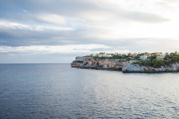 Naklejka premium Picturesque cliffs and rocks over the sea on Mallorca island in Spain. Seascape from the viewing point Es Pontas near Cala Santanyi bay