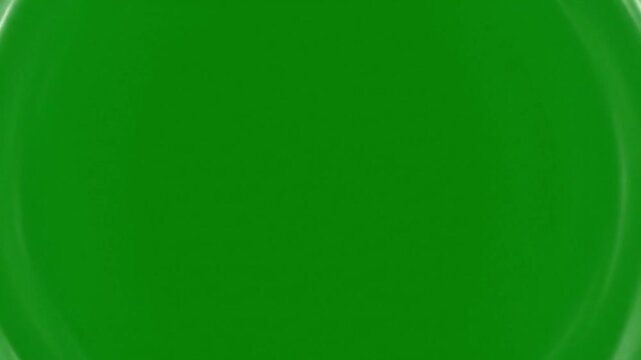 Emerald Plate: An eye-level shot captures a solid green ceramic plate, highlighting its smooth surface and rich color, offering a minimalist aesthetic.