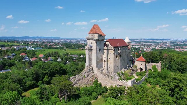 Explore the aerial view of Burg Liechtenstein in Austria, highlighting its impressive architecture and lush green surroundings. Discover the beauty of this historic site.