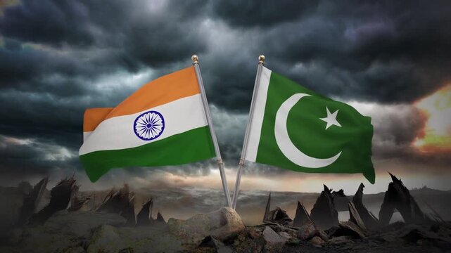 India and Pakistan flags waving in wind against stormy sky and jagged rocky foreground