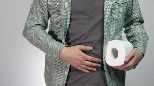 Visualizing acute physical distress. The footage focuses on the physical symptoms of an upset stomach, conveying urgency and discomfort without explicit imagery. Ideal for use in pharmaceutical