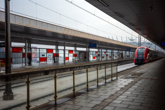 WARSAW, MASOVIAN, POLAND - JANUARY 27 2026: A modern red and cream Szybka Kolej Miejska (SKM) commuter train arrives at the Warsaw Stadium