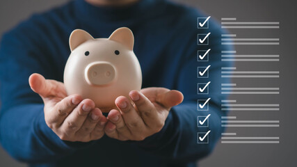 Hands holding a piggy bank with checklist icons, representing financial planning, saving money,...